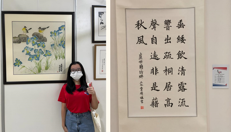 Magdalene with posing beside her Chinese painting and her calligraphy piece 