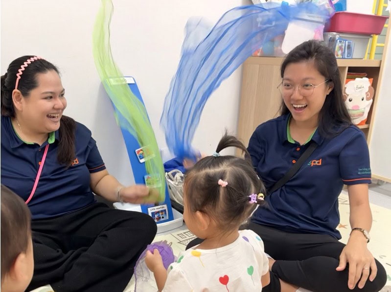 Jia Yi with a fellow EIPIC professional in a music and movement session with young children.