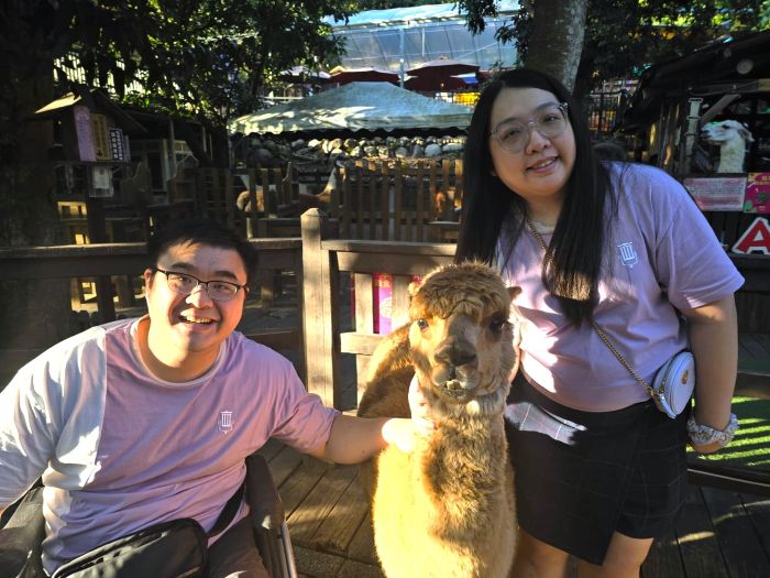 Travel Tips for Wheelchair Users 1 Kishon and his fiancée posing with a sheep