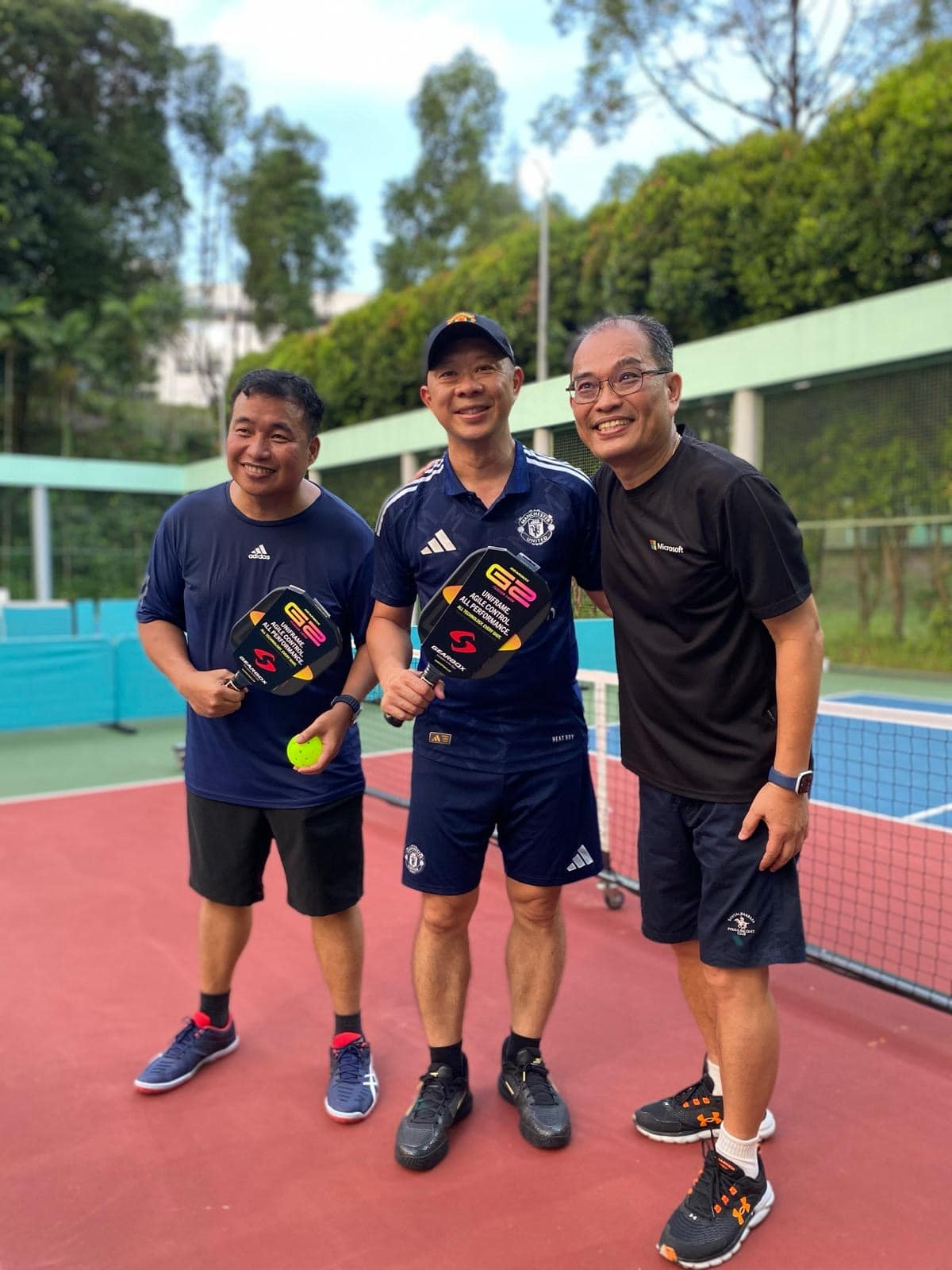 Mr Ong with 2 pickle ball players at the court