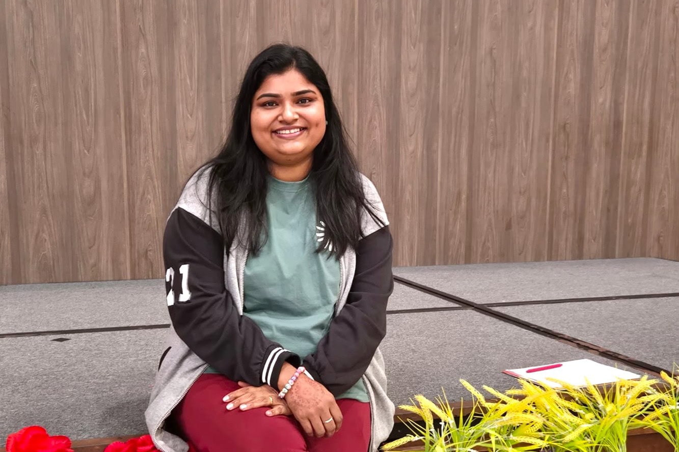 Sindhu seated at a stage area