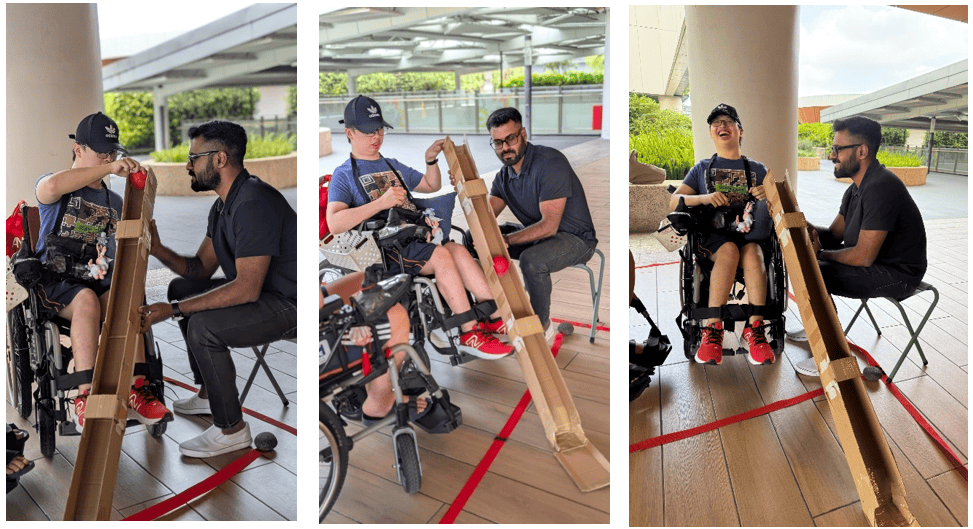 Vinid helping a client position the ramp during a Boccia session