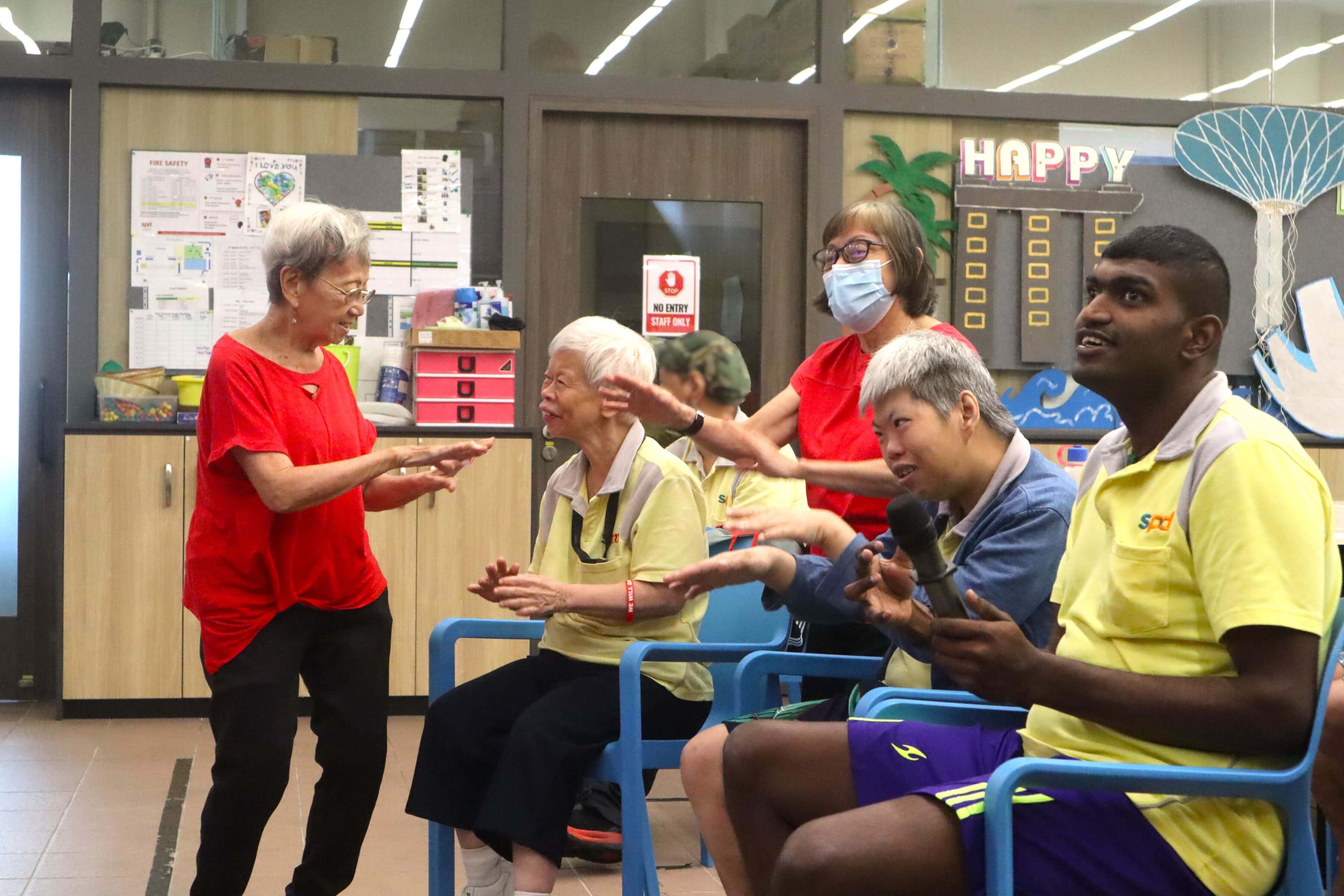 Auntie Molly interacting with some D A C clients in a sing-a-long session