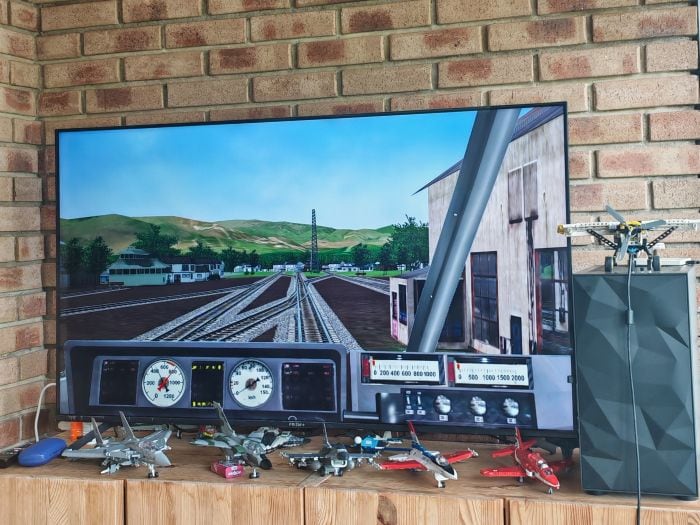 Gamer to Game-Changer: How Zachary is championing accessible technology 2 A television showing a game which is a first person view of a locomotive operator.