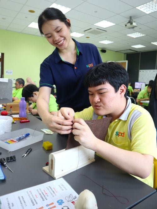 Joel’s independence, built one step and one stitch at a time 2 An S P D workshop supervisor guiding Joel in sewing leather products