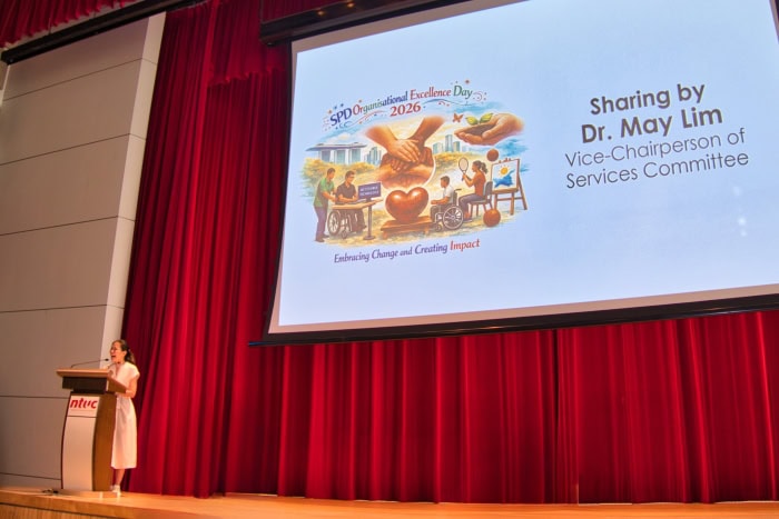 A Working Mum’s Perspective on Excellence - Lessons from Dr May Lim 2 Dr May Lim speaking from the podium at the S P D Organisational Excellence Day