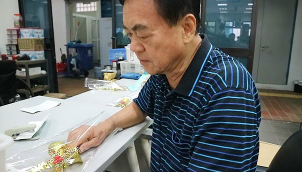 A Familiar Face at the Sheltered Workshop 1 Mr Wang doing some packing at the Sheltered Workshop