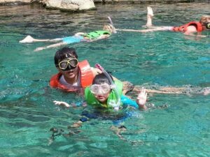 Mr Sim and Aaron in swimming pool with snorkeling gear on 