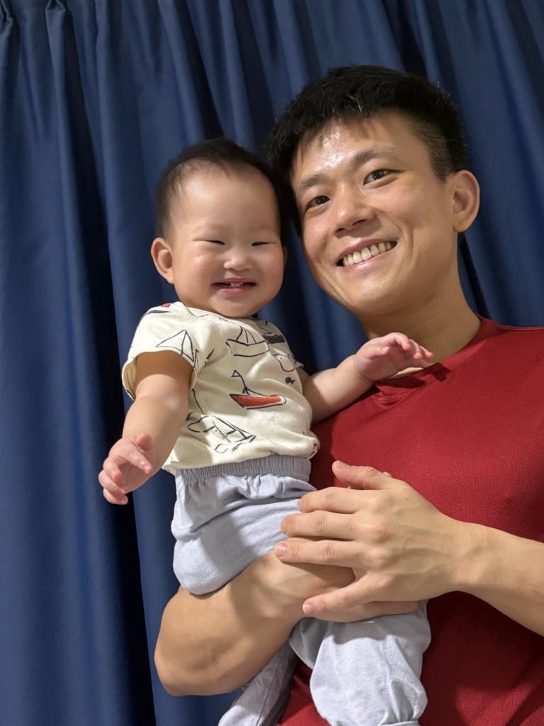 Bradley holding his daughter in his arms