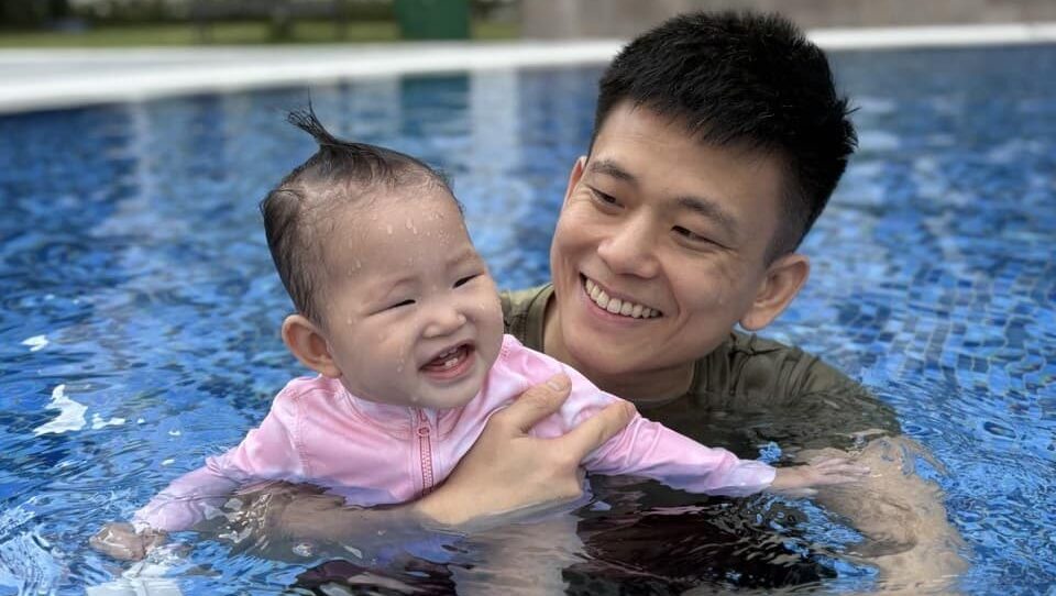 Bradley and daughter smiling in swimming pool